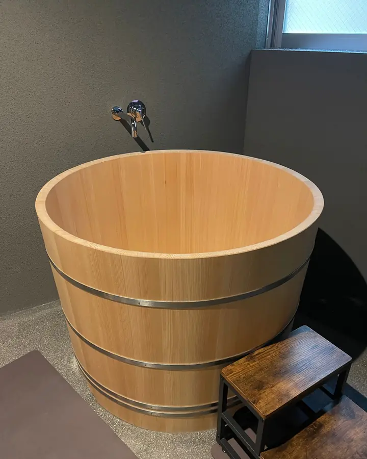 A deep wooden cold-plunge soaking tub